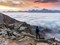 Hiker admires the sea of clouds from the Becca di Viou